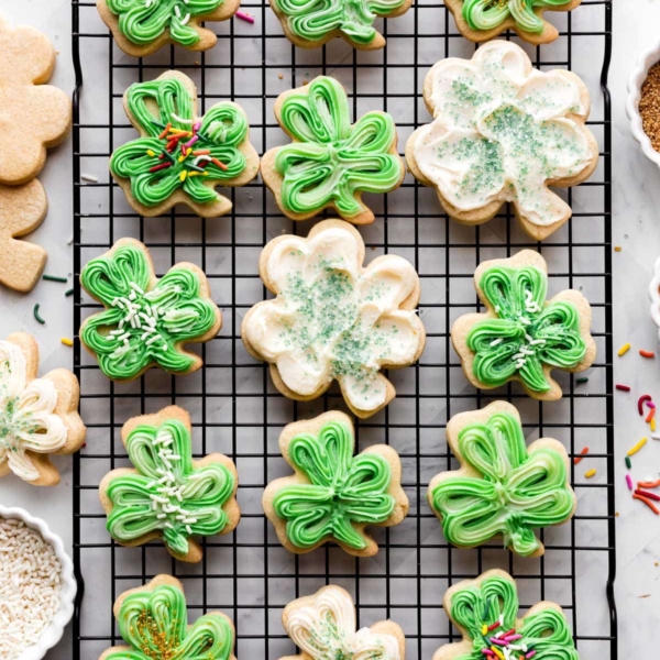 shamrock shaped sugar cookies with green and white buttercream frosting