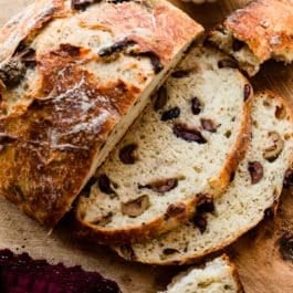 slices of olive bread shown with small bowl of olives