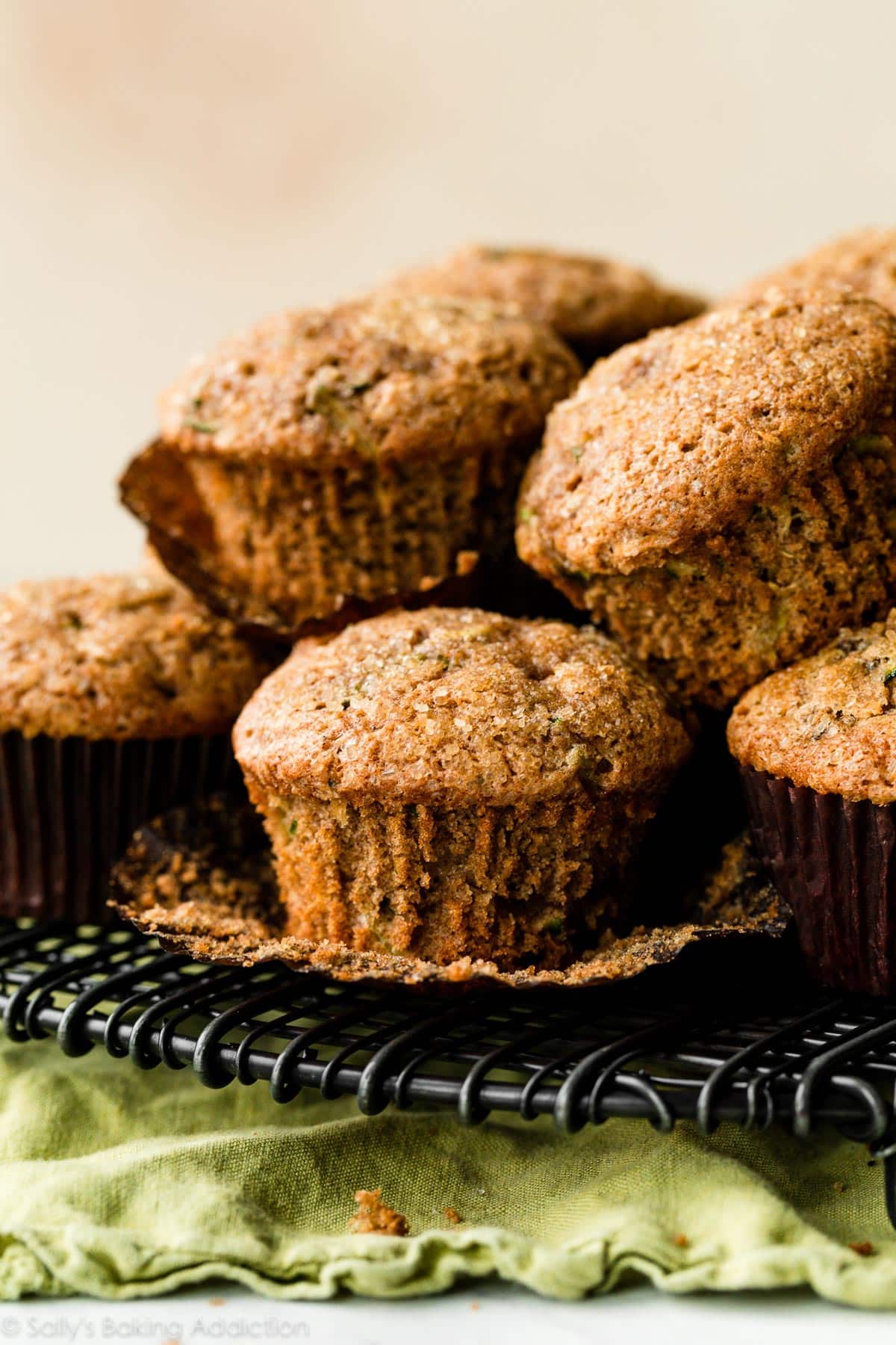 zucchini muffins piled on cooling rack