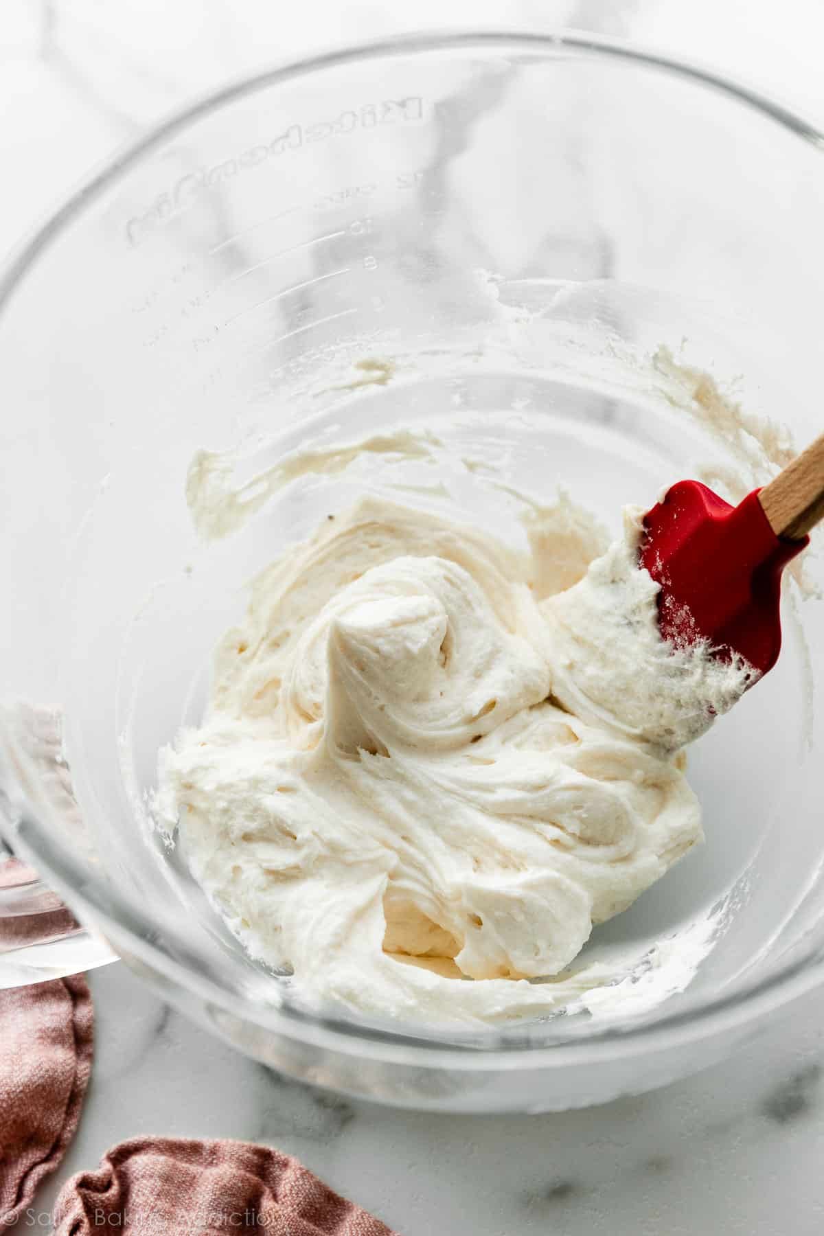 whipped vanilla buttercream frosting in glass bowl.