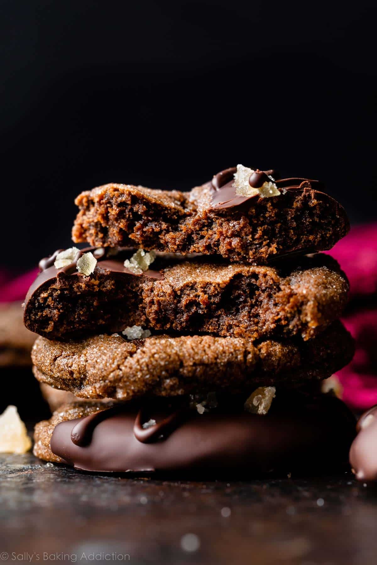 stack of chocolate ginger cookies with top two cookies broken in half.