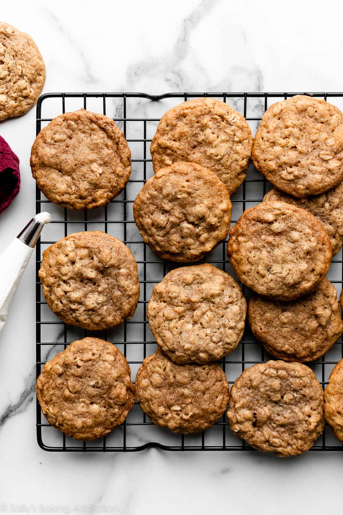 oatmeal cookies on black wire cooling rack.