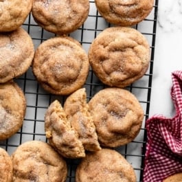 peanut butter snickerdoodles on black wire cooling rack.