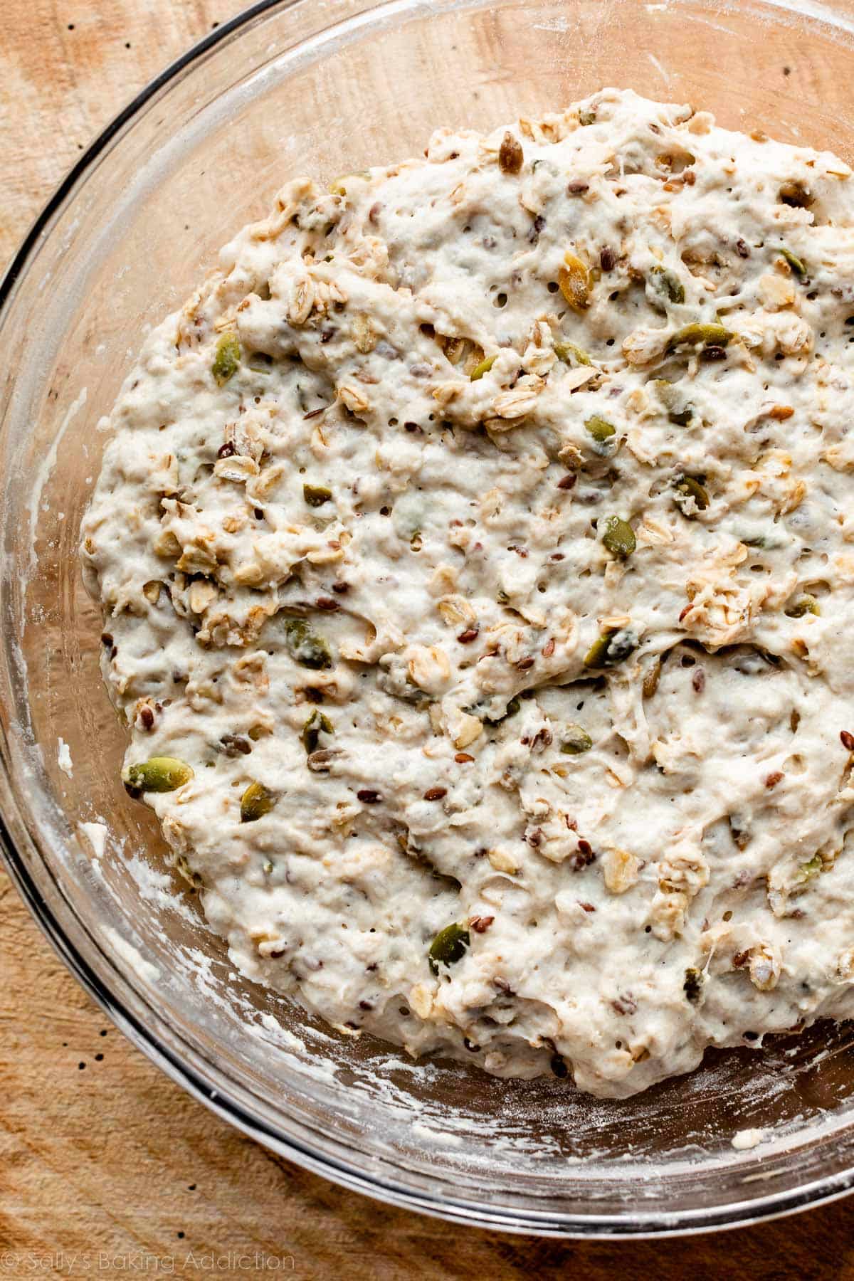 dough with seeds in it in glass bowl.