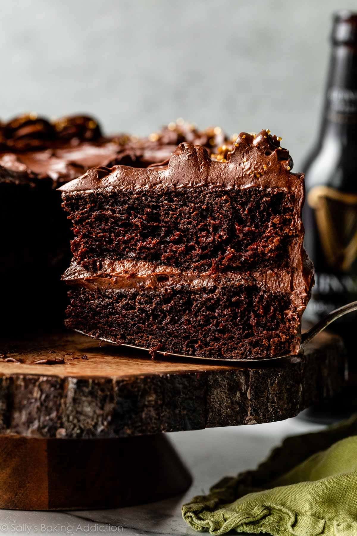 slice of Guinness cake being removed from cake stand.