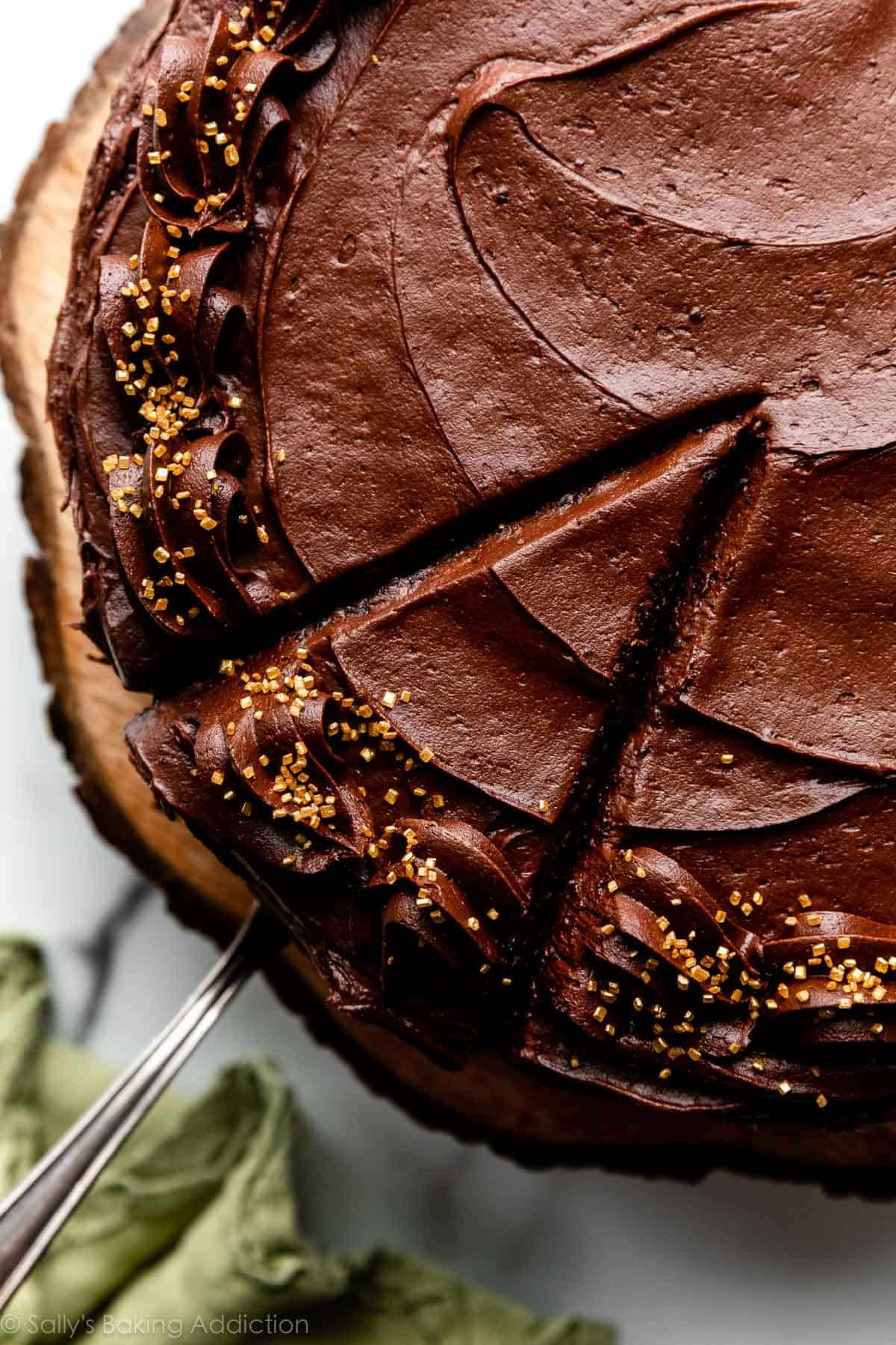 top of cake with chocolate frosting and gold sprinkles around the edges.