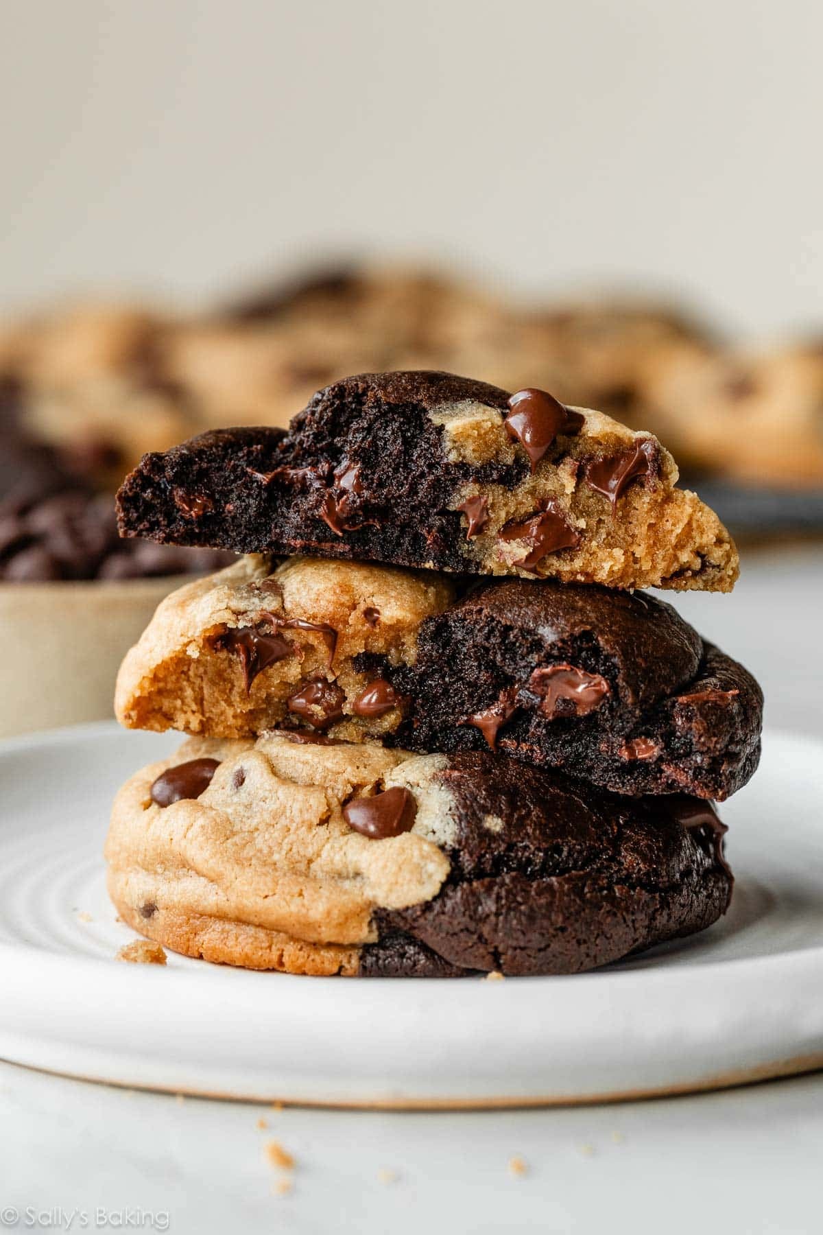 stack of peanut butter chocolate swirl cookies with 1 cut in half to see inside.