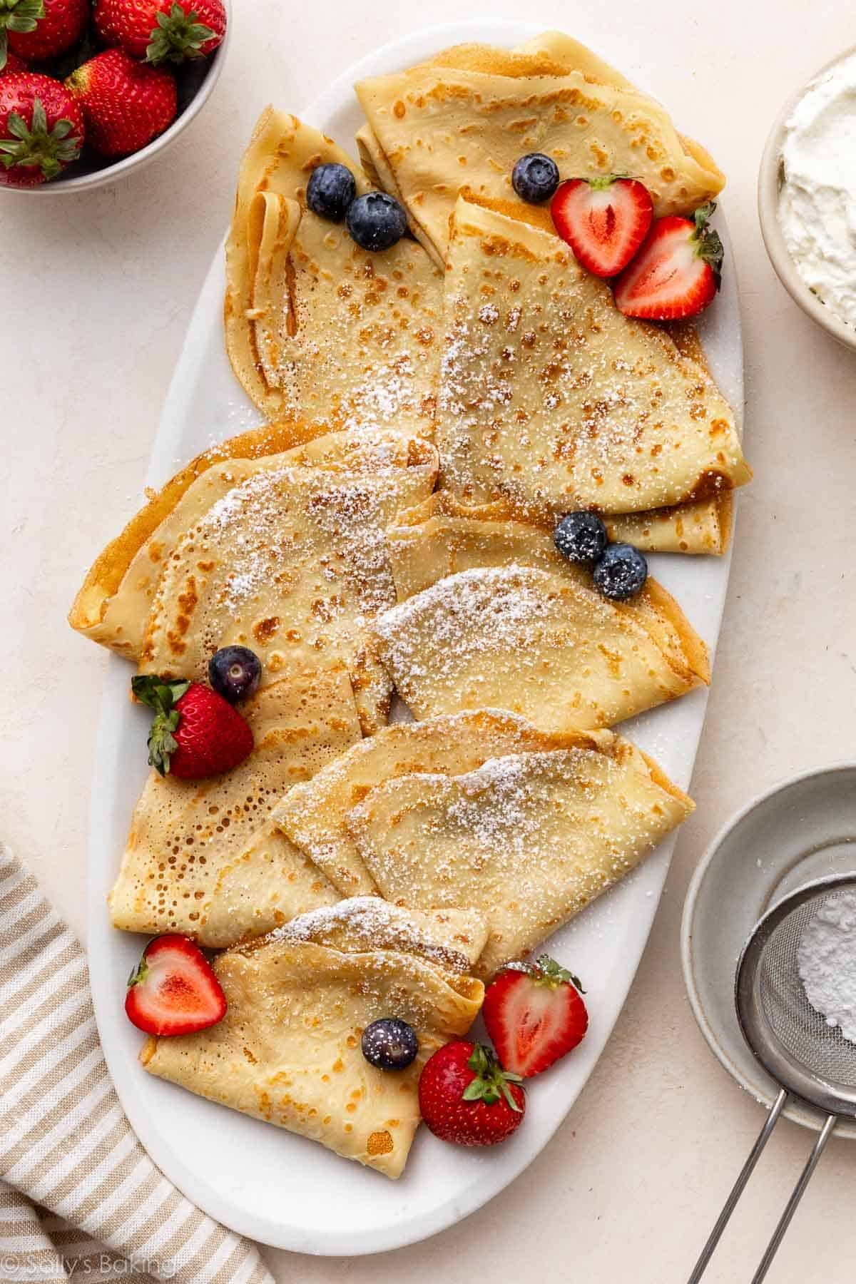 crepes on platter with berries.