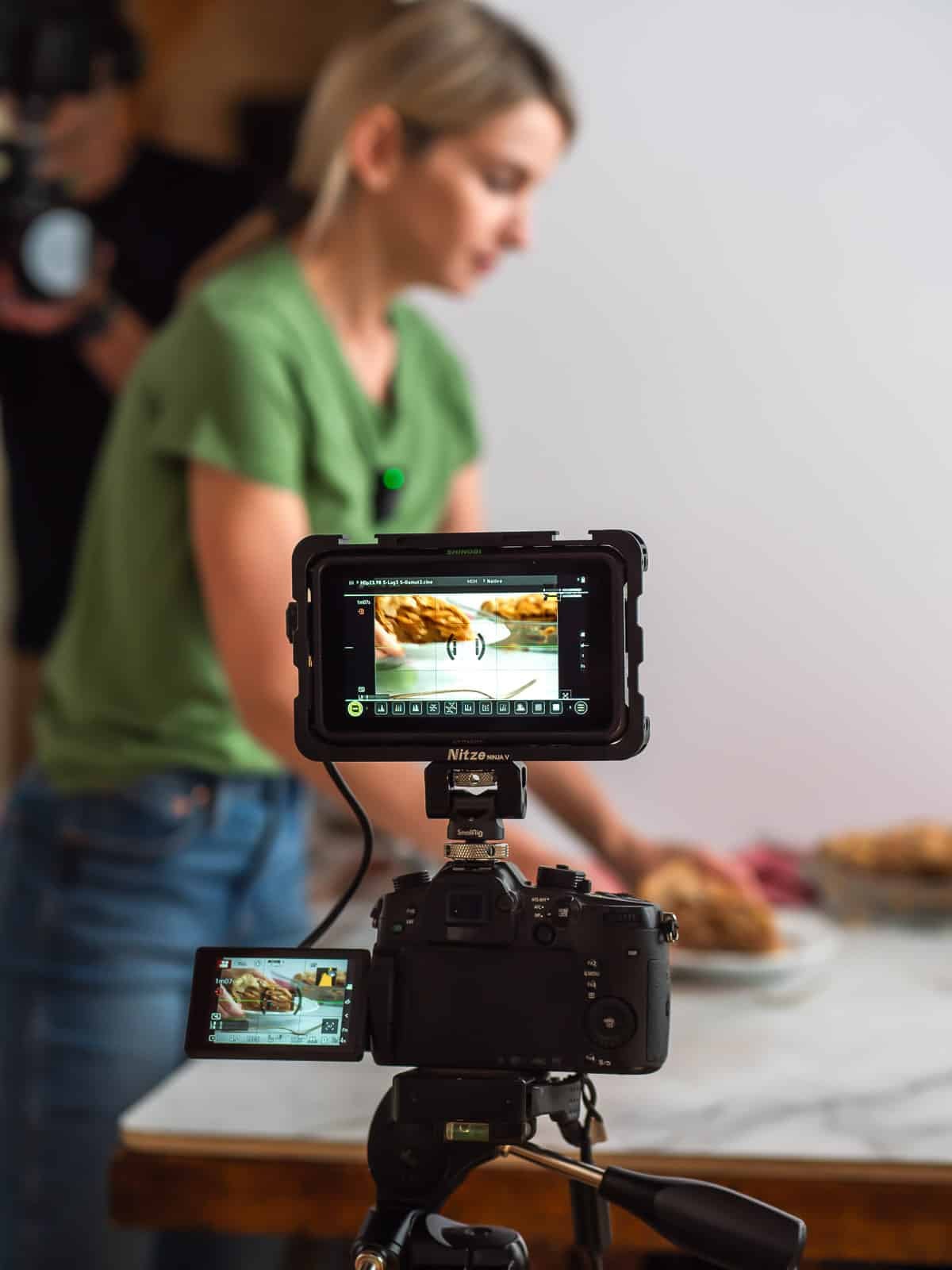 Sally in background holding pie slice behind camera.