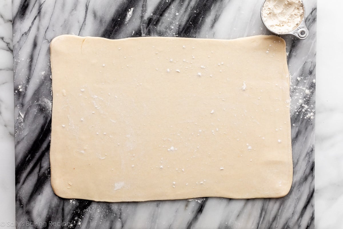 rolled out dough on marble surface.