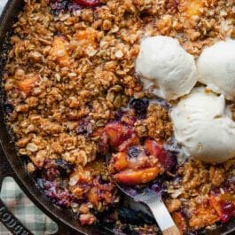 brown butter blueberry peach crisp in cast iron skillet.