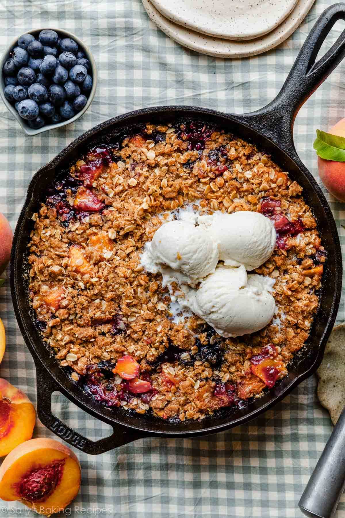 brown butter blueberry peach crisp in cast iron skillet.