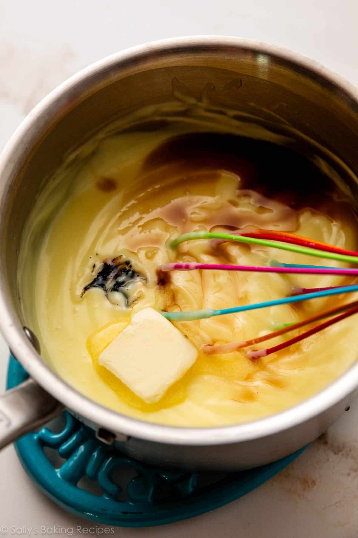 vanilla and butter on top of pastry cream in pot.