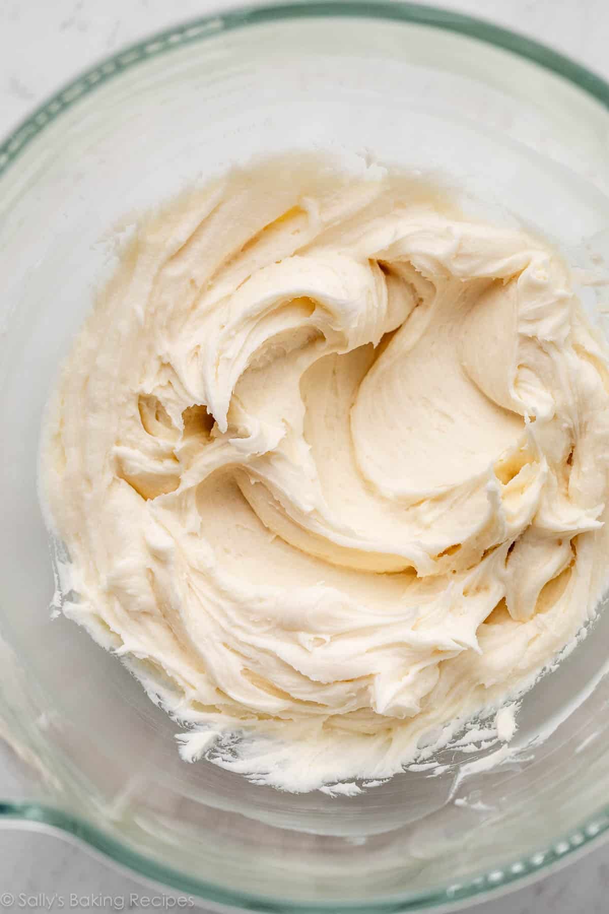 close-up overhead photo of buttercream frosting in glass bowl.