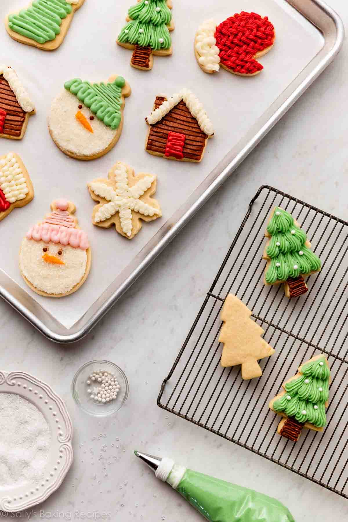 decorated cookies on a baking sheet and on a cooling rack.