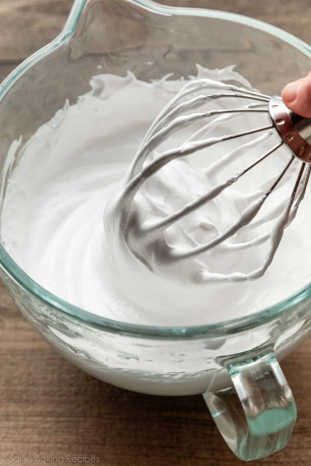 marshmallow mixture with whisk attachment in glass bowl.