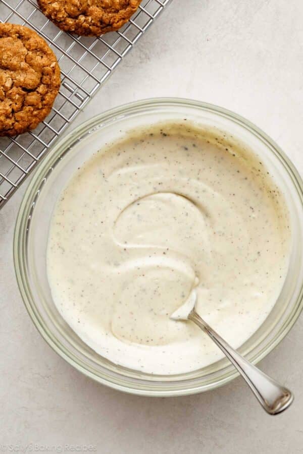 espresso powder speckled melted white chocolate in a glass bowl.
