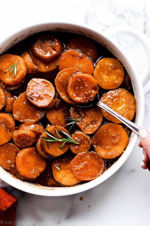 candied sweet potatoes Thanksgiving side dish in round white baking dish.