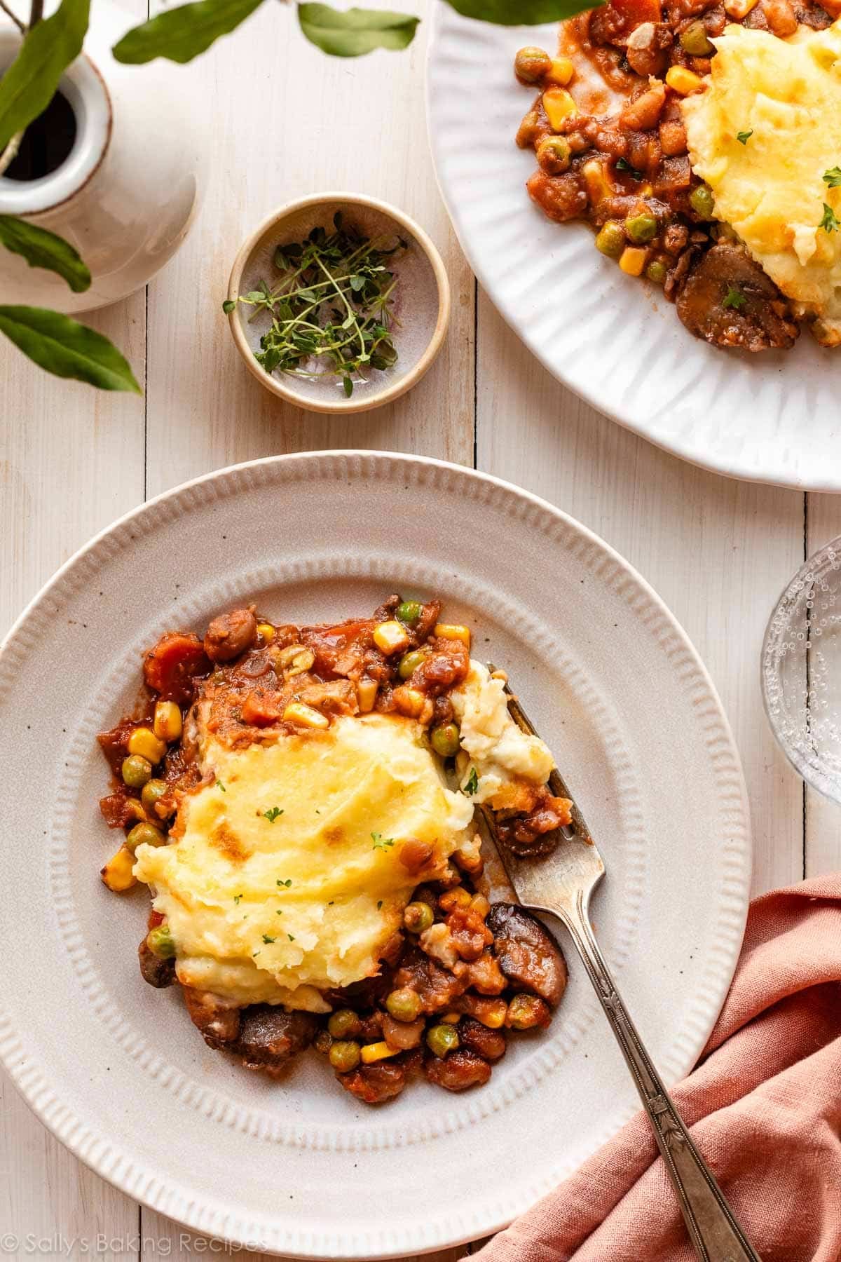 servings of vegetarian vegetable shepherd's pie on white plates.