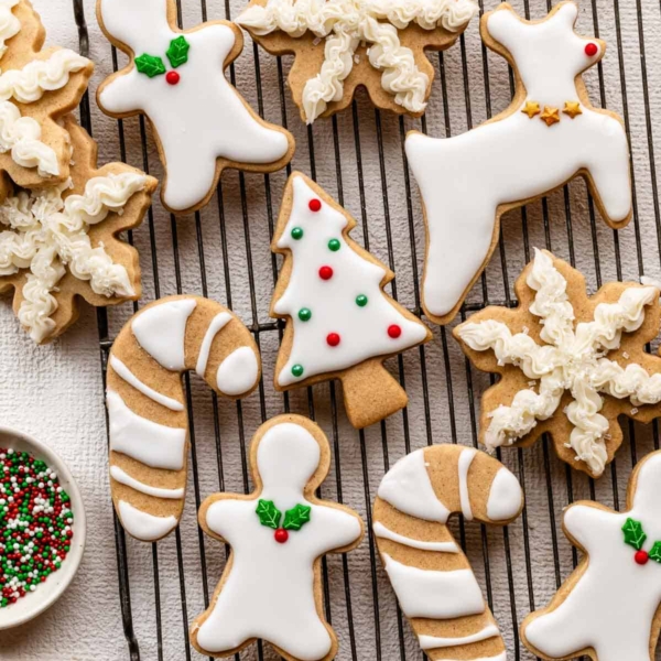 decorated brown sugar cut-out cookies in various shapes including reindeer, candy canes, and snowflakes.