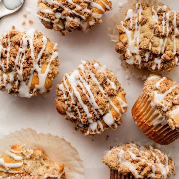 crumb cake muffins with icing on top.