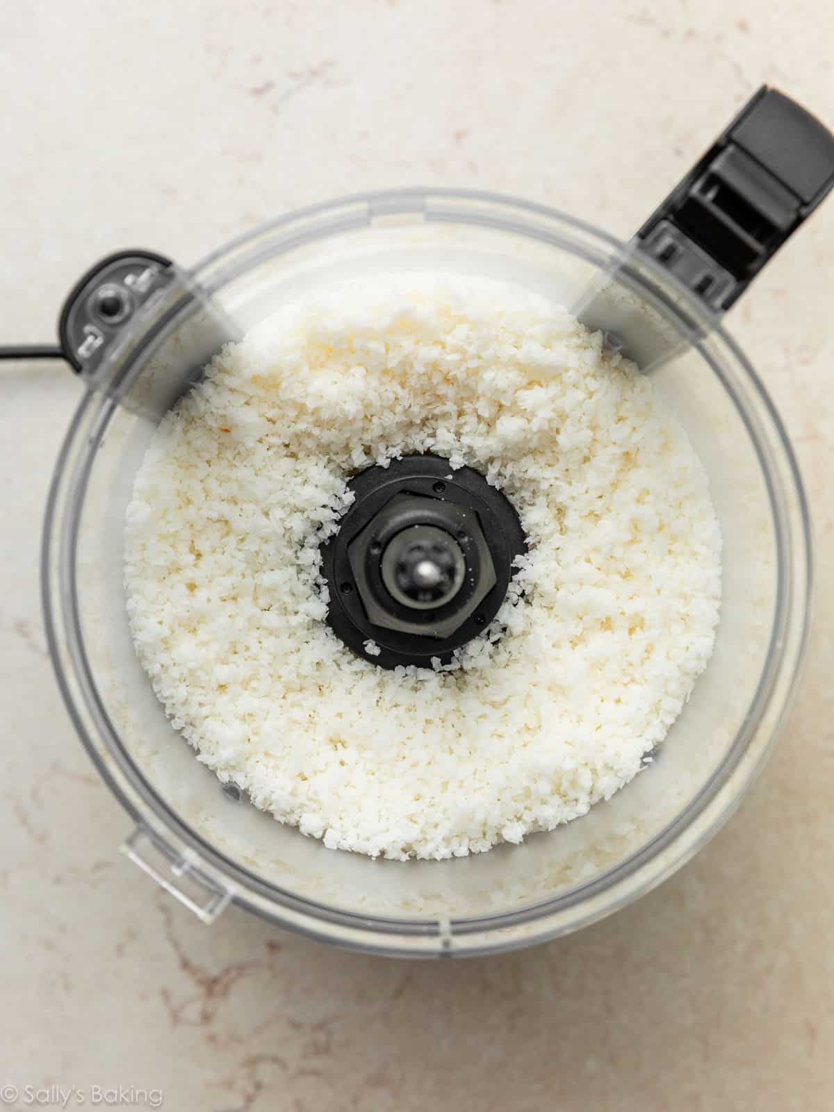 pulsed coconut in food processor bowl.