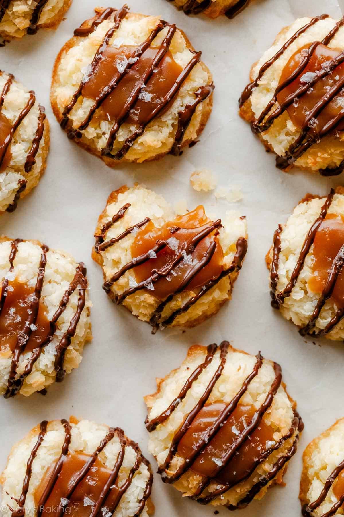 close-up overhead photo of coconut macaroon thumbprints filled with caramel and drizzled with chocolate.