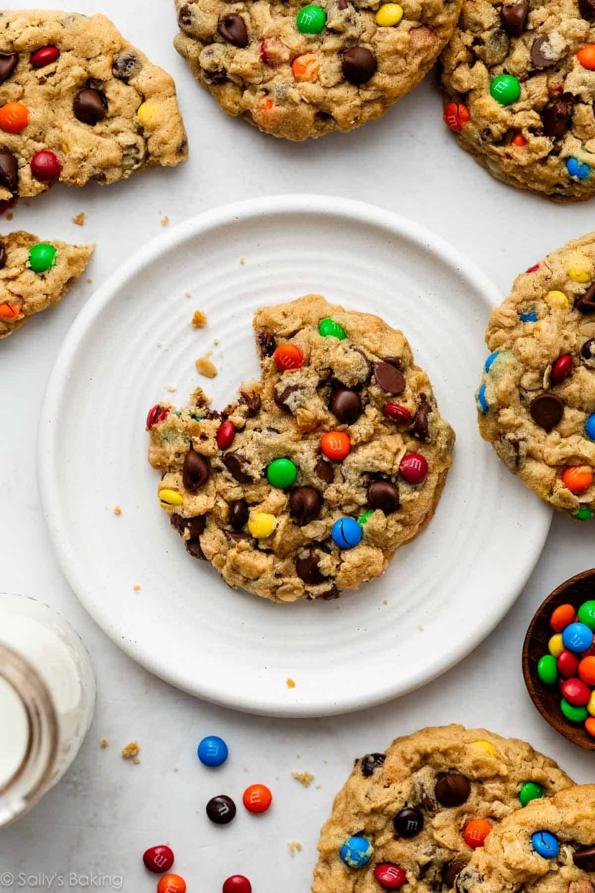 monster cookie with a bite taken out on white plate.