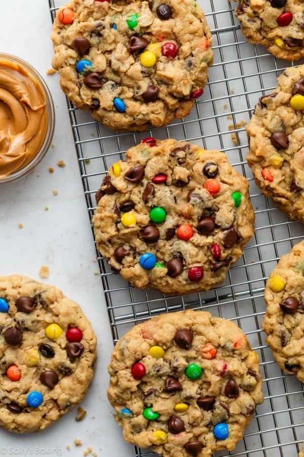 monster cookies with M&Ms on cooling rack.