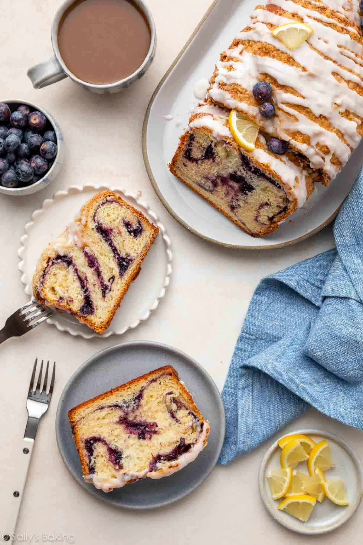 blueberry babka on serving platter and babka slices on plates.