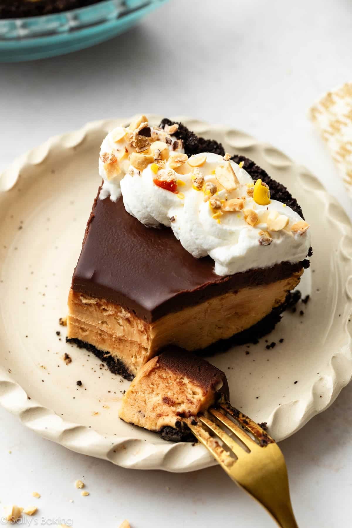 slice of peanut butter pie topped with whipped cream.
