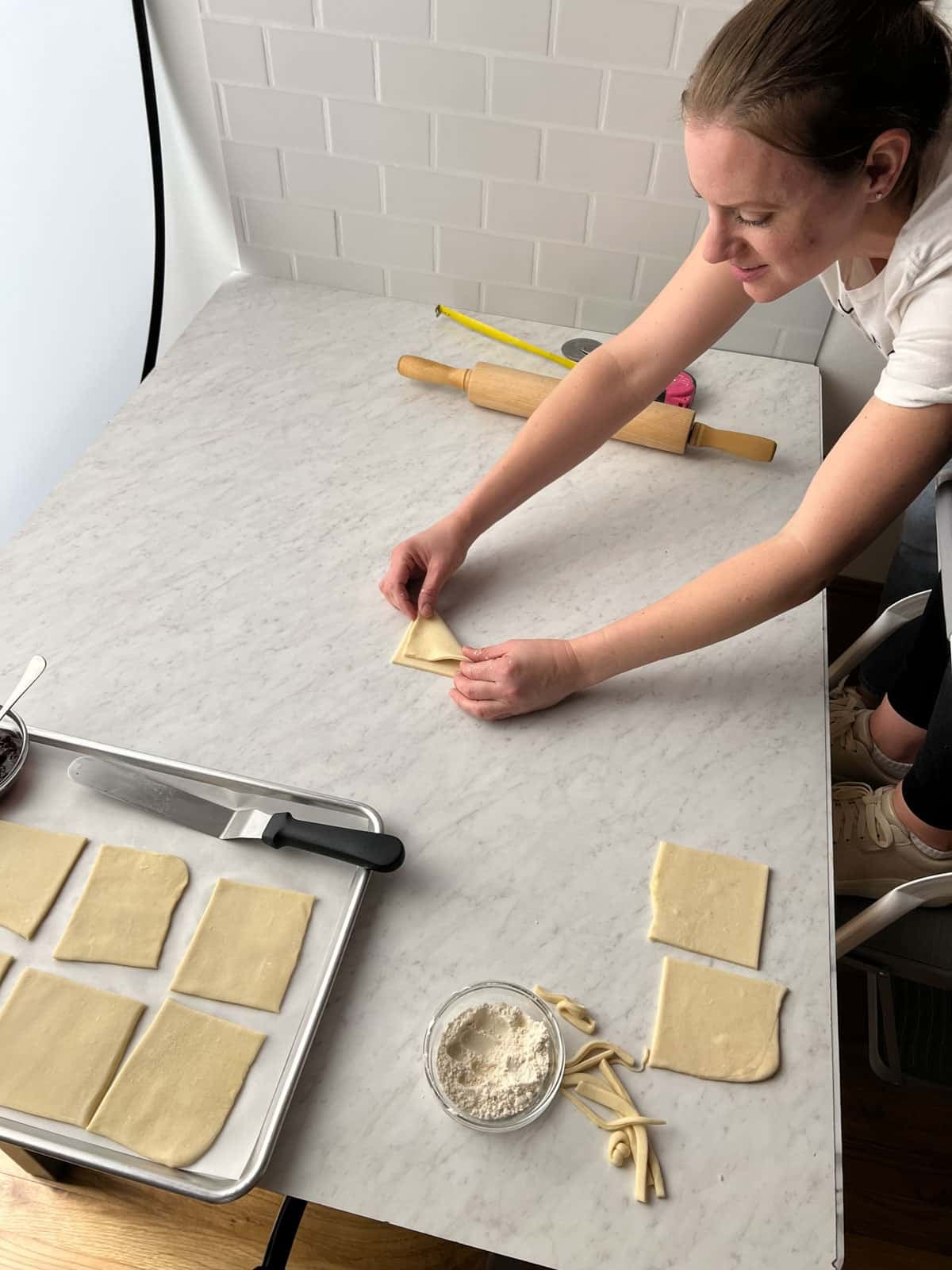 Beth folding dough square.