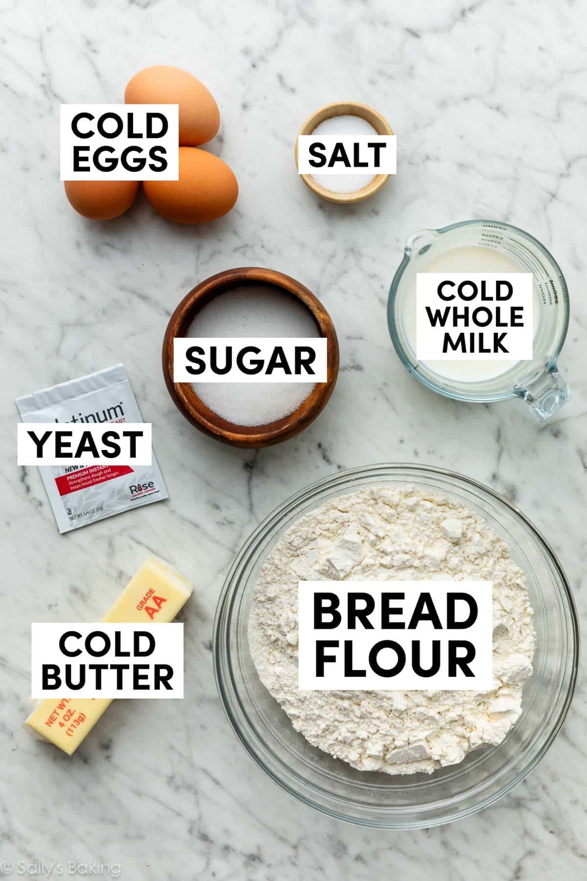 ingredients in bowls including bread flour, sugar, salt, eggs, and milk.