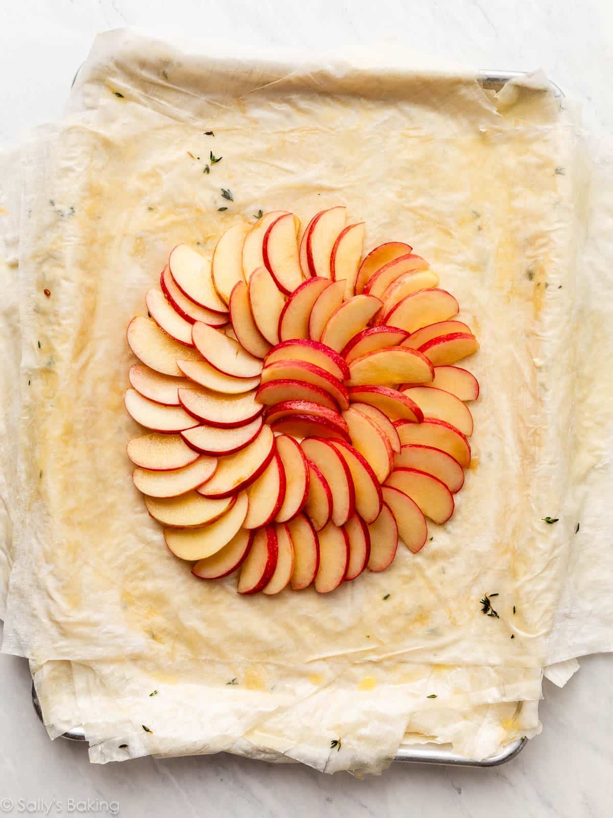 arranged apples on top of crust dough.
