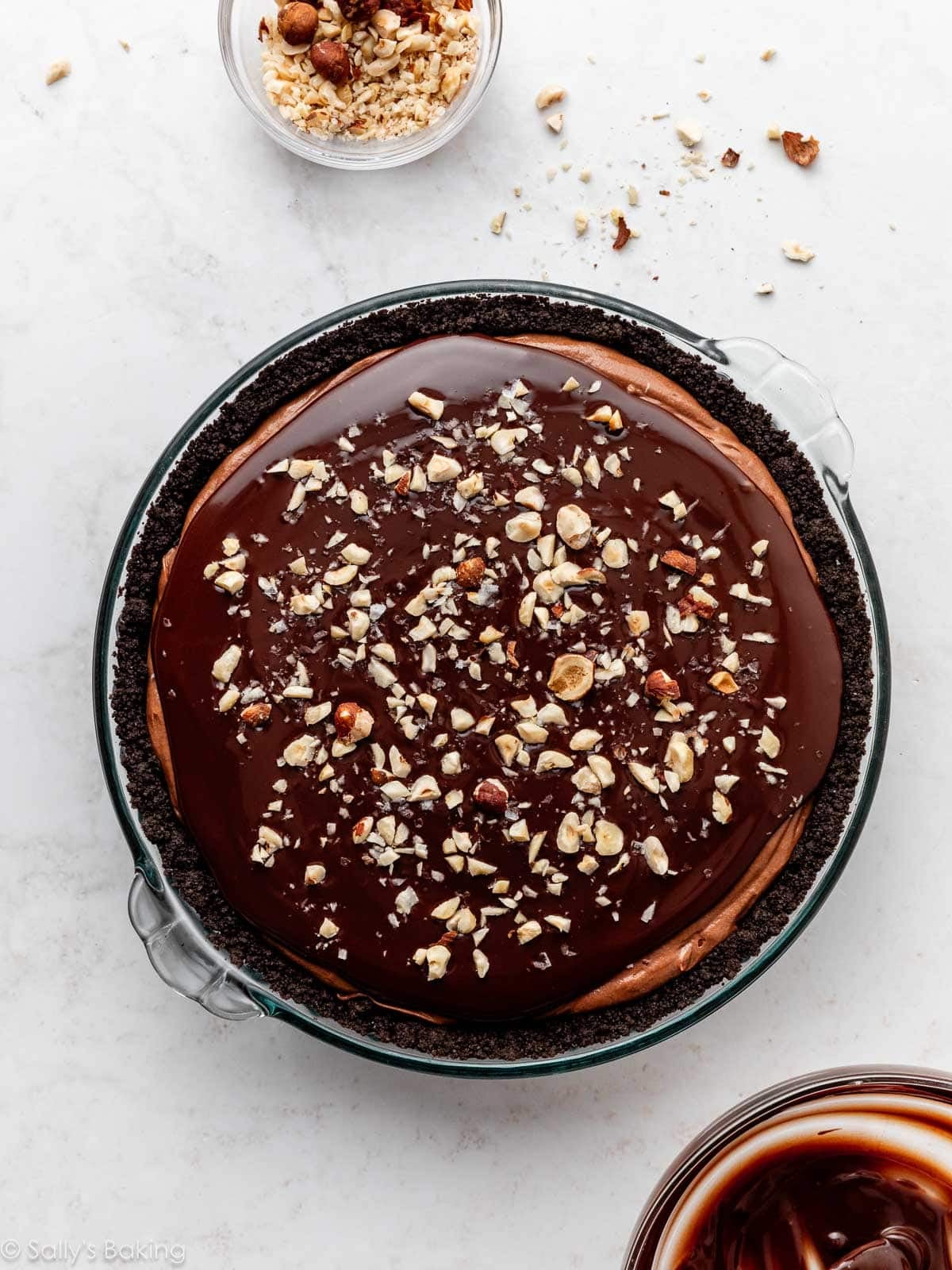 ganache and hazelnuts on top of pie.
