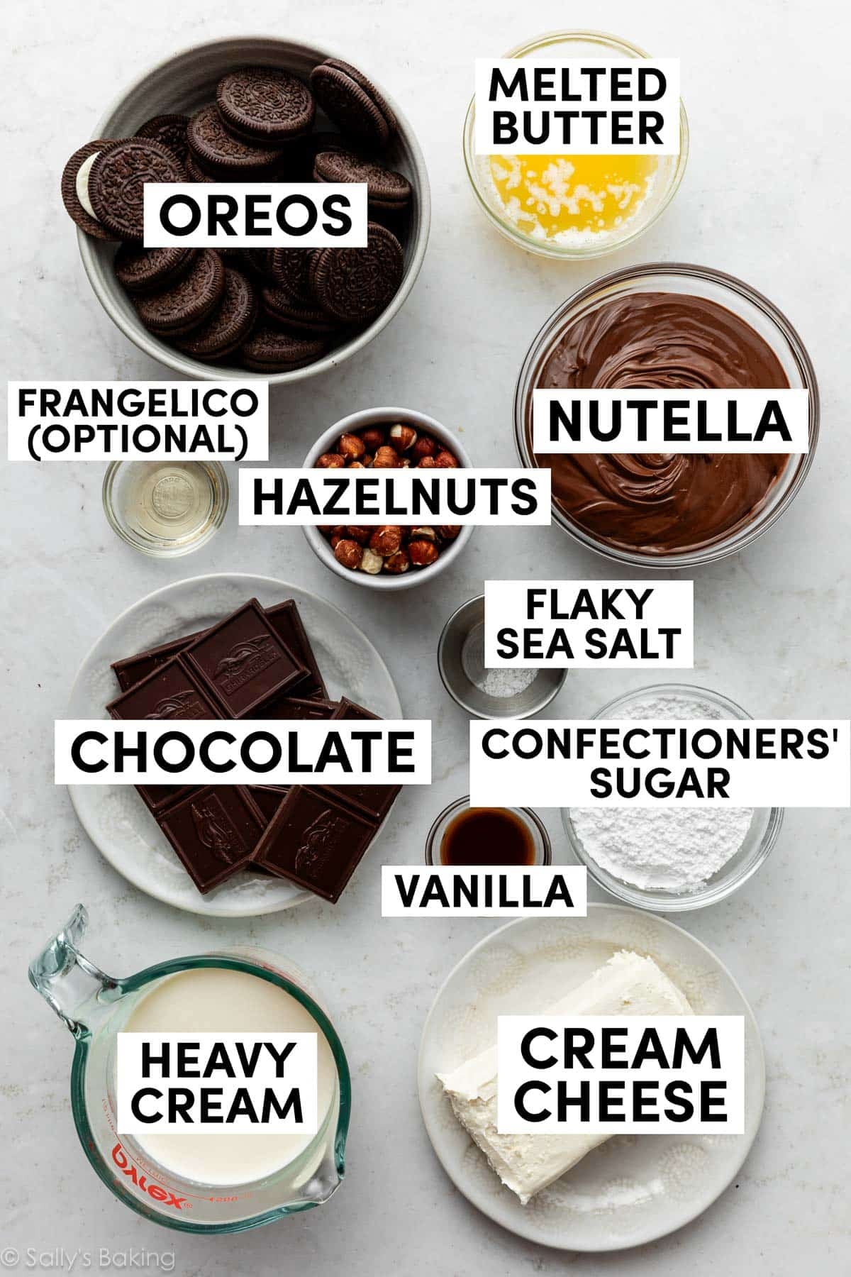 Oreos, heavy cream, cream cheese, hazelnuts, and ingredients in bowls.
