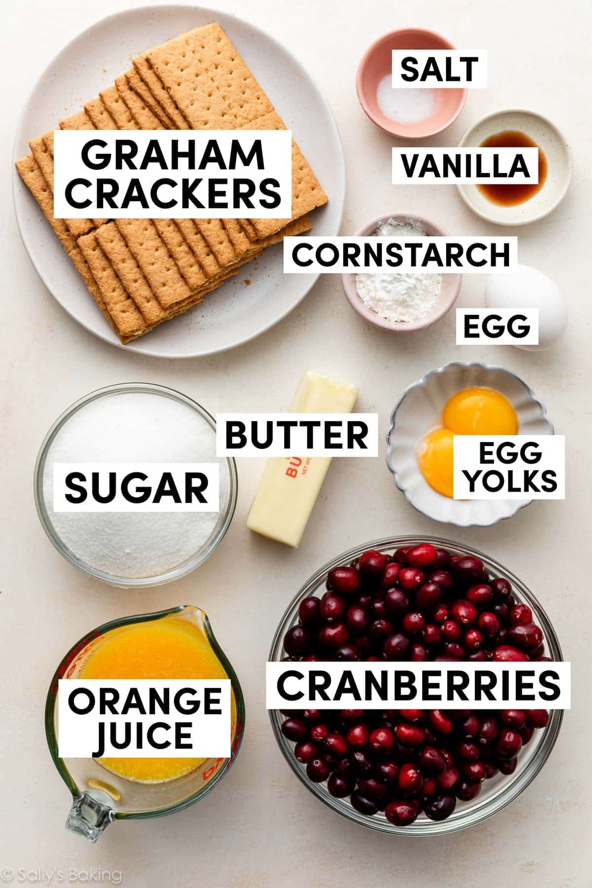 ingredients measured in bowls including cranberries, graham crackers, orange juice, egg yolks, and butter.