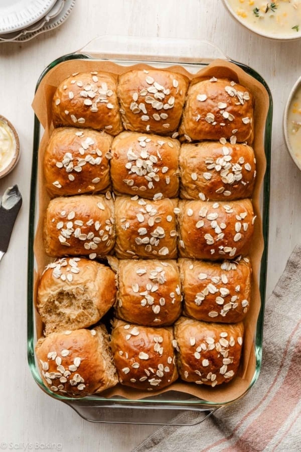 oatmeal molasses dinner rolls with oats on top.