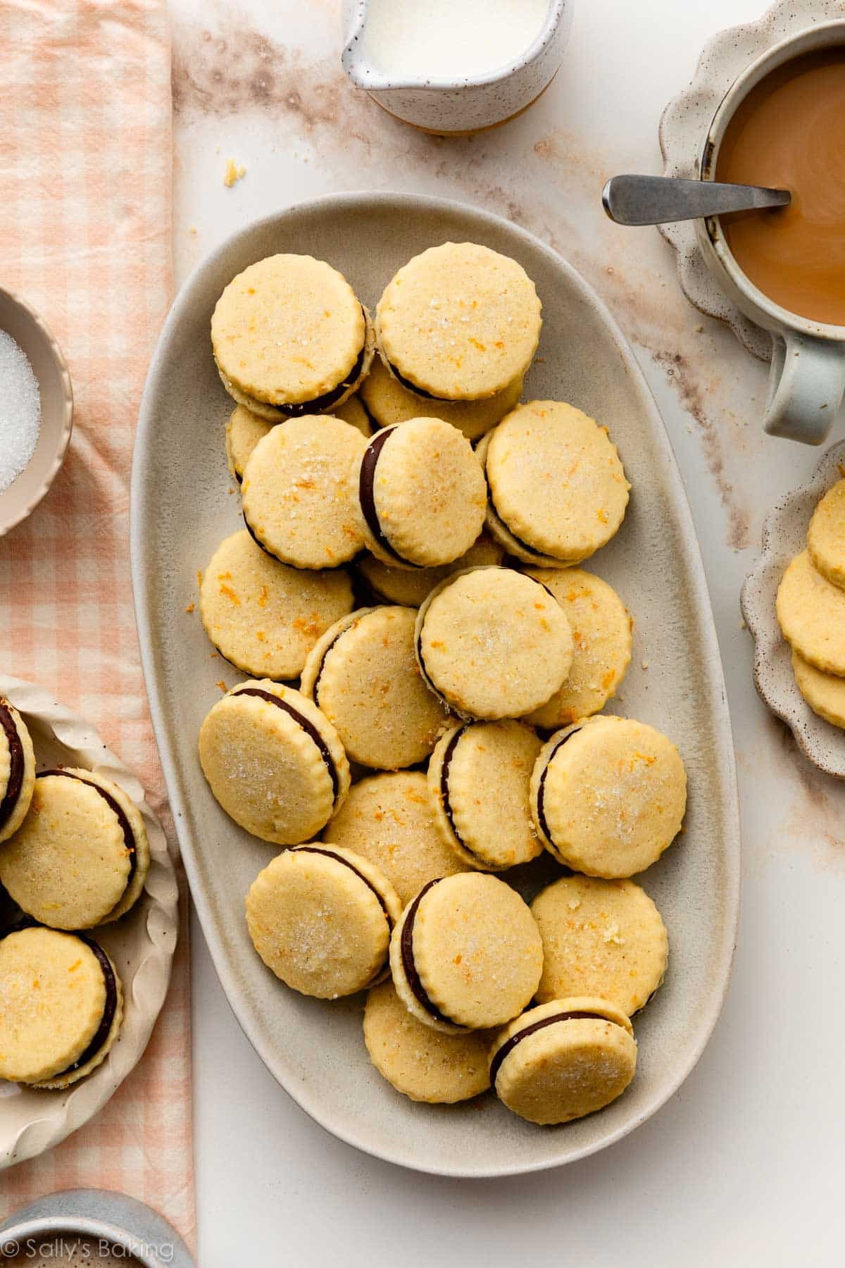 orange butter cookie sandwiches with chocolate ganache filling on oval platter.
