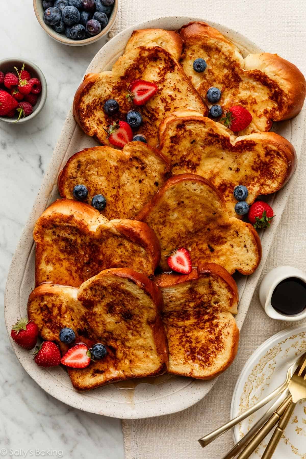brioche french toast on platter with fresh berries.