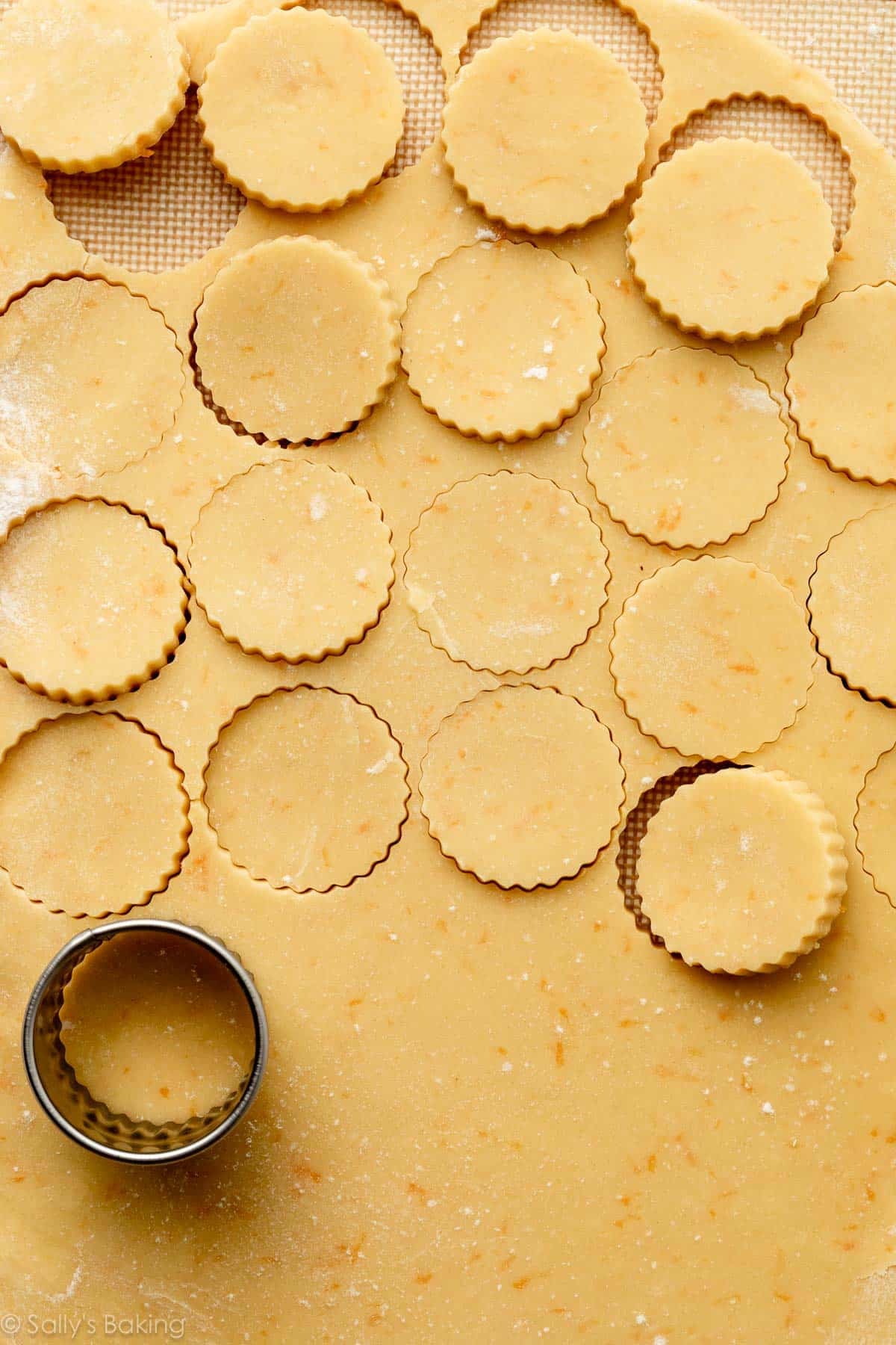 orange zested-dough rolled out and cut into ruffled-edge circles.