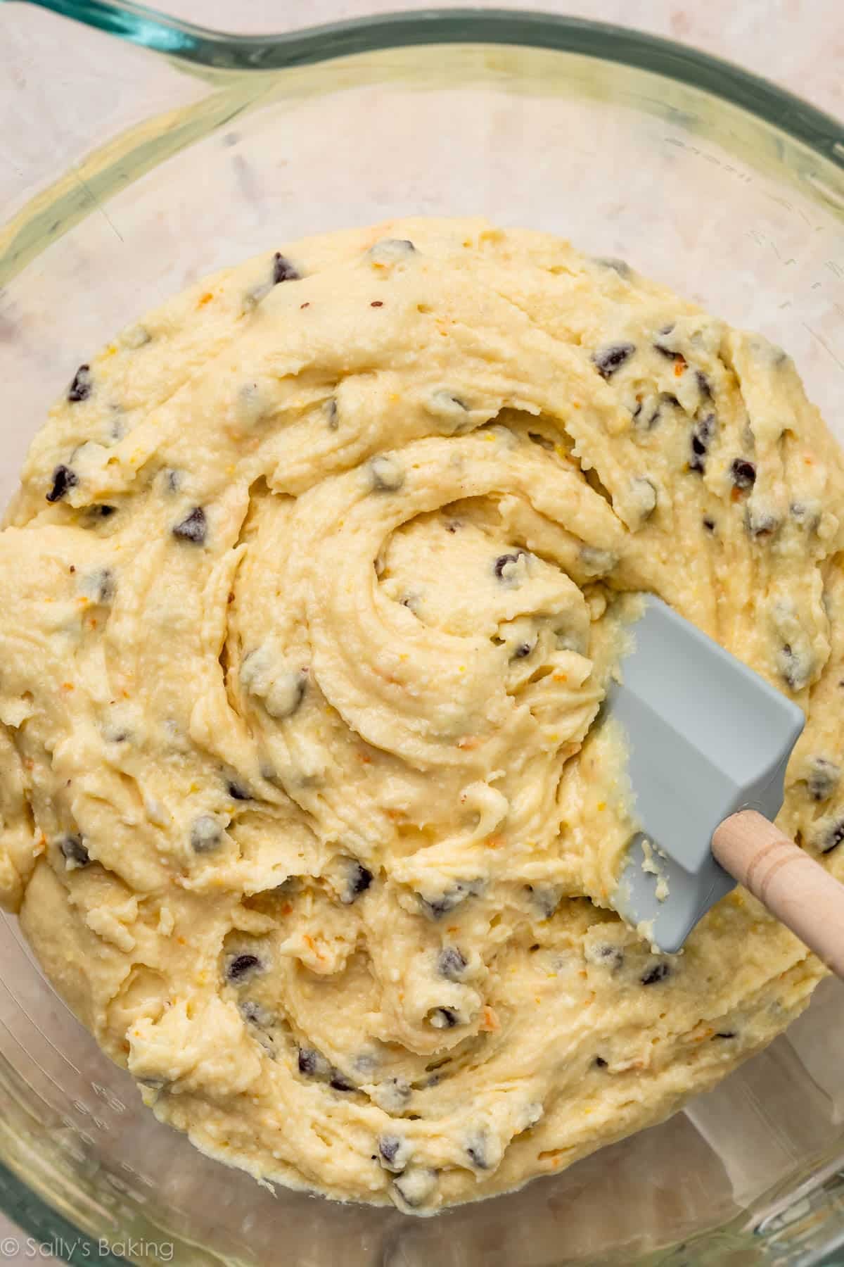 chocolate chip batter with blue spatula in bowl.