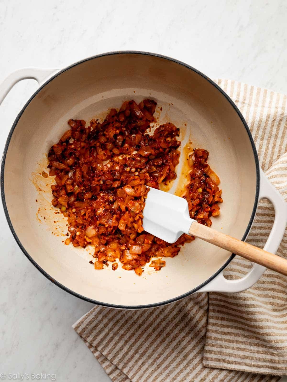 sautéed onions, garlic, and herbs in pot.