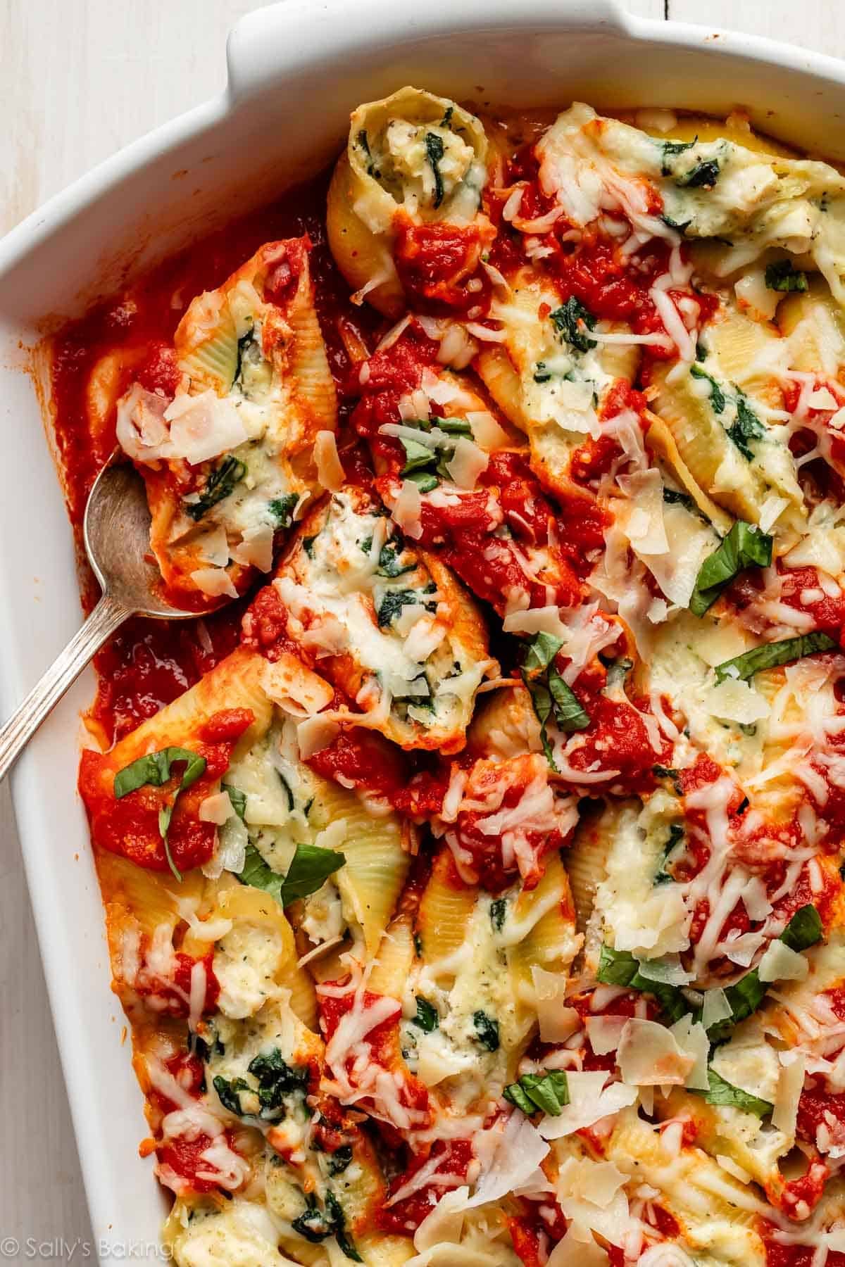 creamy chicken stuffed shells with marinara and garlic spinach.