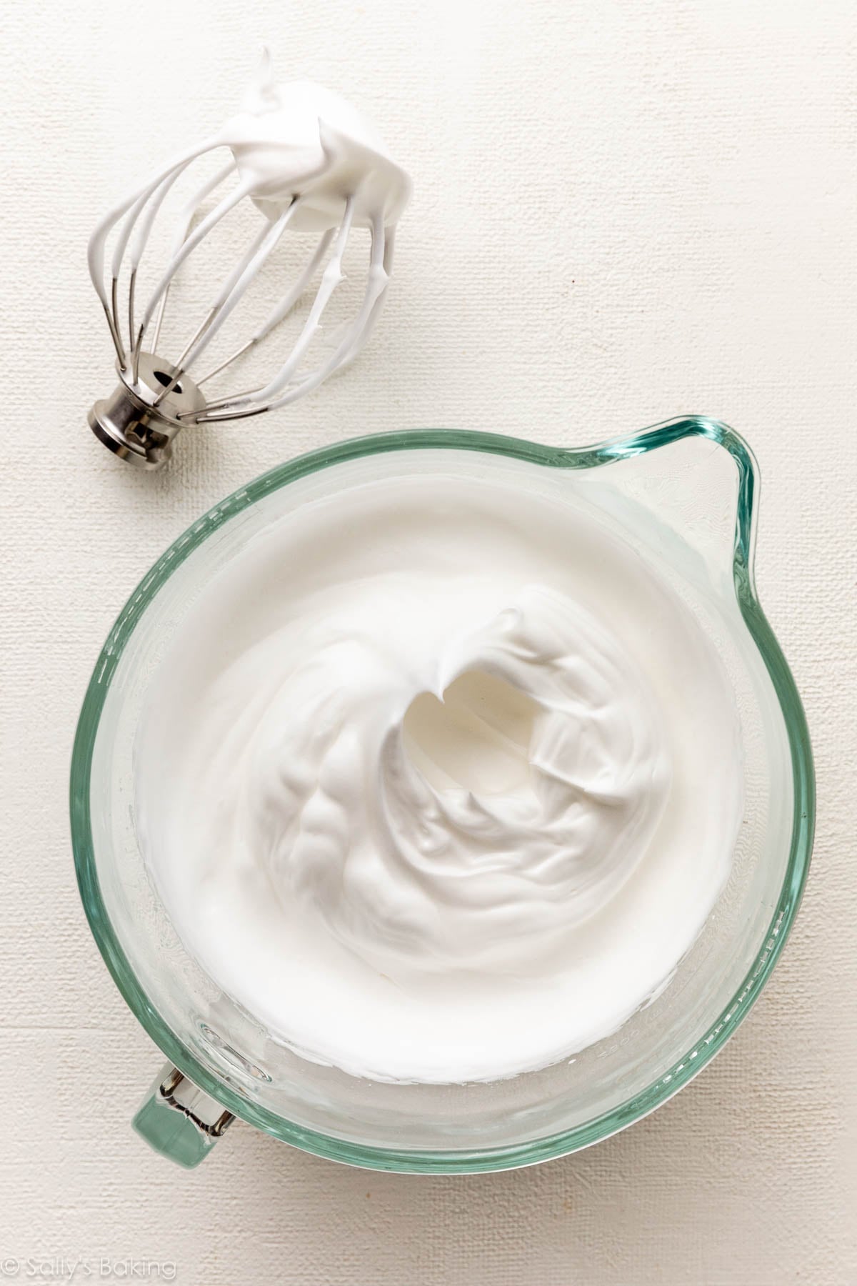 whipped egg whites in glass bowl.