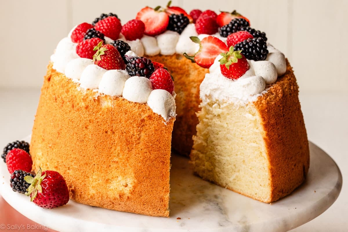 chiffon cake with whipped cream and berries on top.