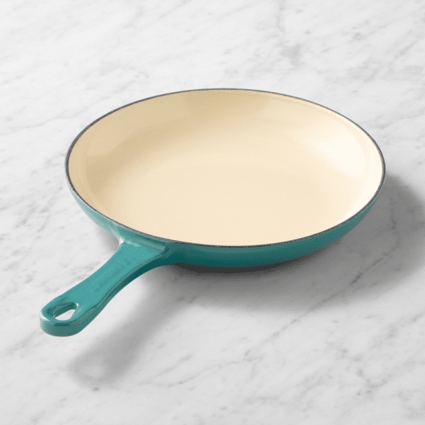 teal skillet with white interior.